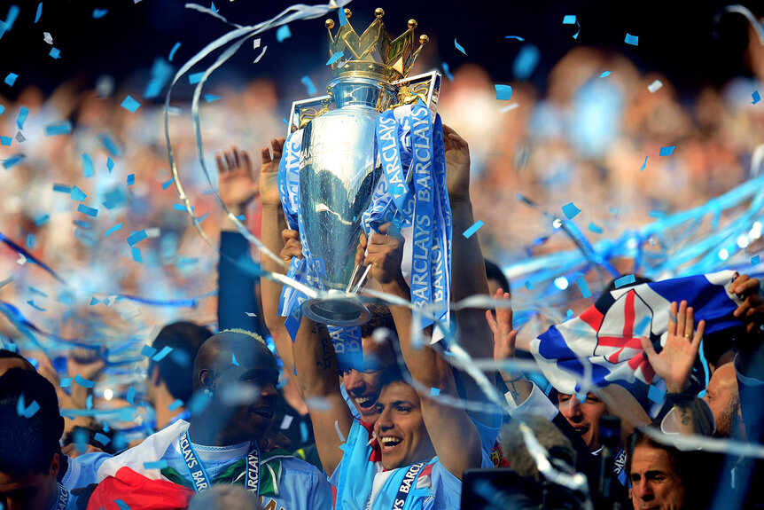 Sergio Aguero of Manchester City celebrates with the trophy during the Barclays Premier League match between Manchester City and Queens Park Rangers