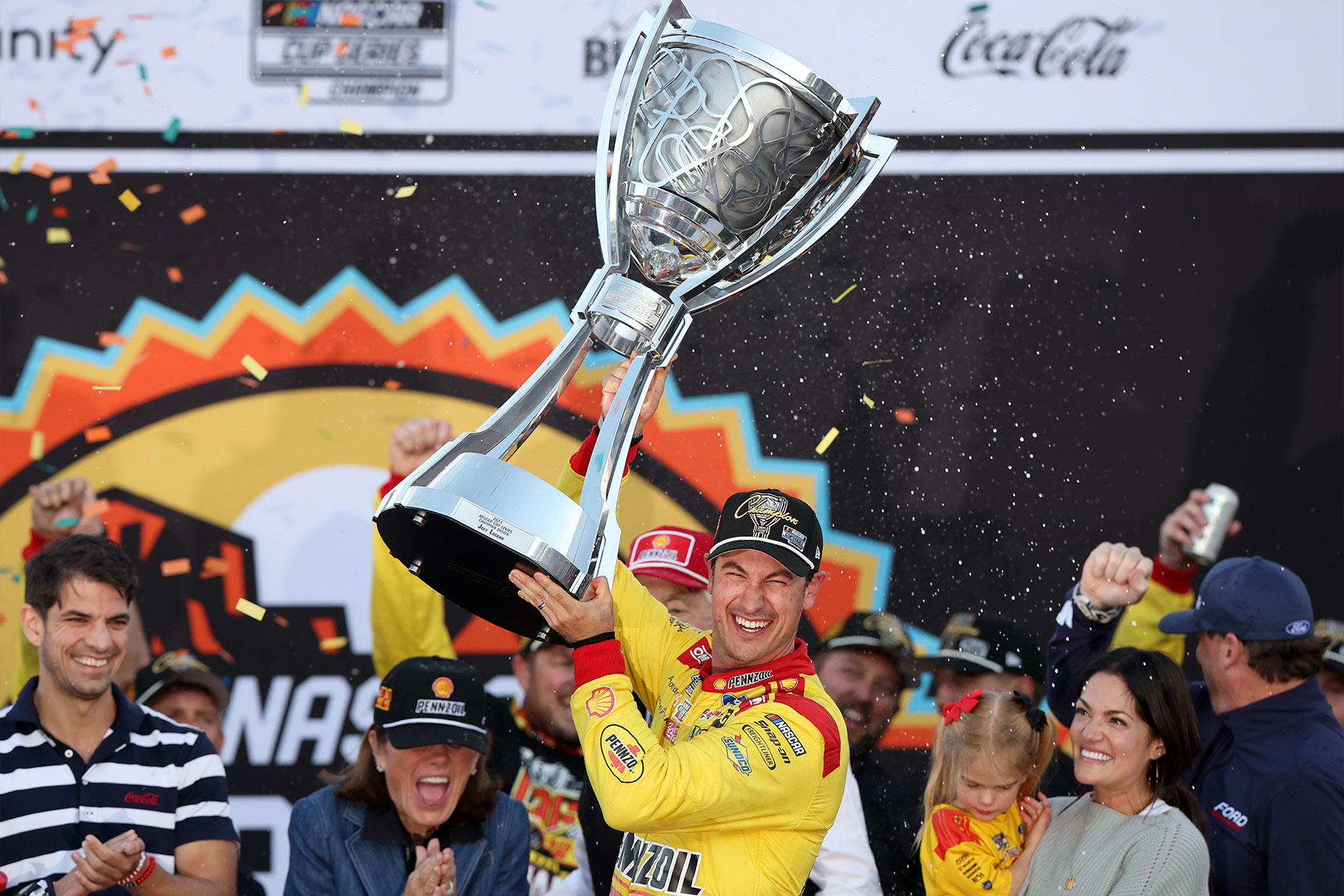 Joey Logano celebrates with the Bill France NASCAR Cup Series Championship trophy