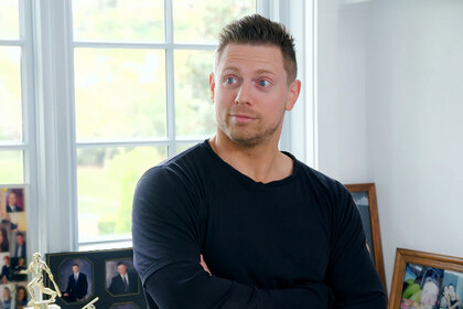 The Miz wearing a long sleeve black shirt with a surprised look on his face