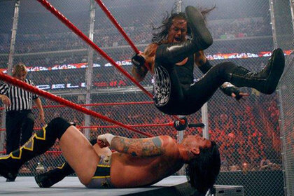 The Undertaker sitting on CMPunk in their 2005 Hell in a Cell match