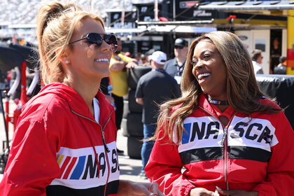 Whitney And Mariel wearing red nascar jackets and laughing together