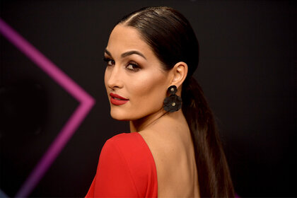 Nikki Bella looking over her shoulder, posing for the camera