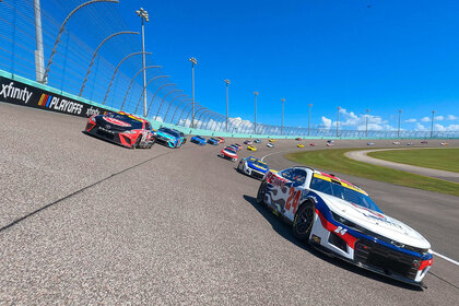 William Byron, driver of the #24 Liberty University Chevrolet, and Christopher Bell, driver of the #20 Rheem - WATTS Toyota, lead the field on a pace lap prior to the NASCAR Cup Series Dixie Vodka 400