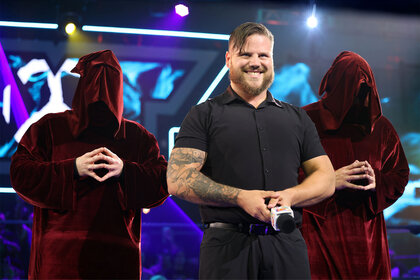 Joe Gacy in the ring with a big, creepy smile on his face