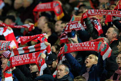 Liverpool fans hold scarves aloft during the UEFA Champions League group A match