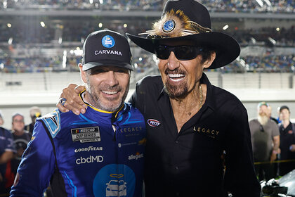 Jimmie Johnson, driver of the #84 Carvana Chevrolet, (L) and NASCAR Hall of Famer Richard Petty pose for photos prior to the NASCAR Cup Series Bluegreen Vacations Duel #1 at Daytona International Speedway