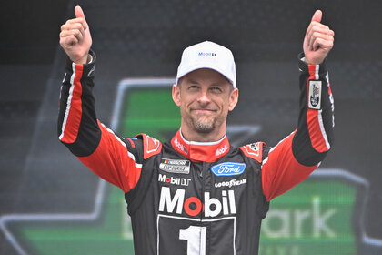 Jenson Button, driver of the #15 Mobil 1 Ford, gives a thumbs up to fans as he walks onstage during driver intros prior to the NASCAR Cup Series EchoPark Automotive Grand Prix at Circuit of The Americas