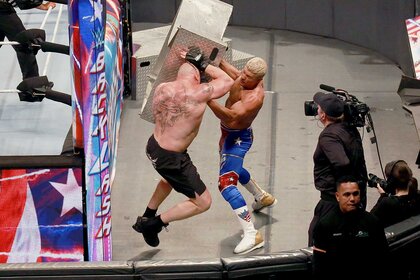 Cody Rhodes and Brock Lesnar fight each other outside the ring