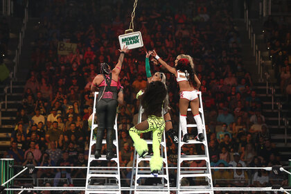 Four wrestlers climb ladders to get to the Money In The Bank briefcase