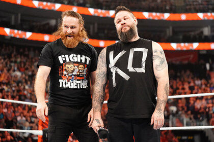 Kevin Owens and Sami Zayn stand in the ring together