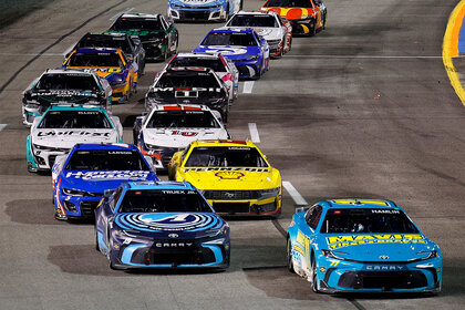 A bunch of cars driving during the NASCAR Cup Series
