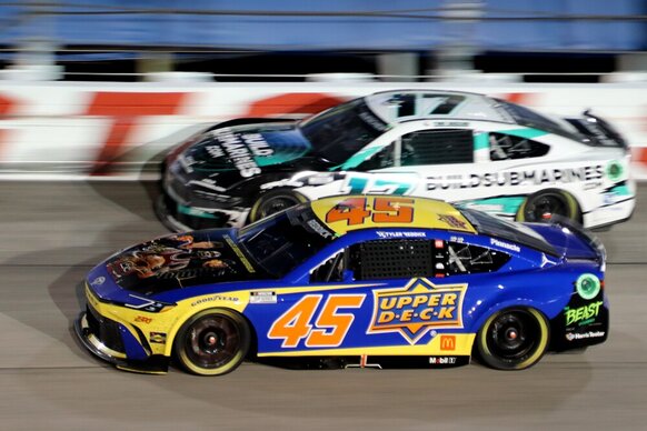 Tyler Reddick races with Chris Buescher into turn 2 during the running of the 75th Cook Out Southern 500