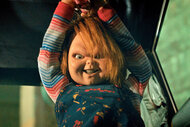 Chucky holds up a knife with an evil smile on his face on Chucky Episode 303