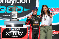 Tyler Reddick and his girlfriend Alexa Deleon celebrate winning the NASCAR Xfinity Series MoneyLion 300 race on April 27, 2019