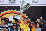 Joey Logano celebrates with the Bill France NASCAR Cup Series Championship trophy