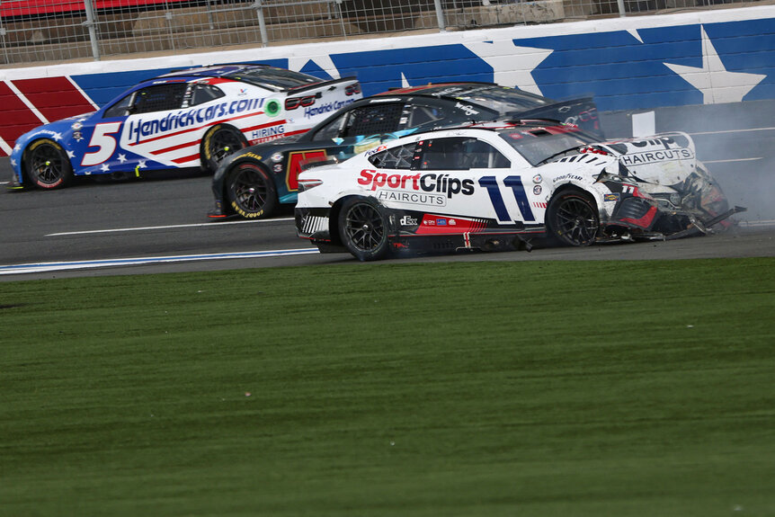 Denny Hamlin, driver of the #11 Sport Clips Haircuts Toyota, spins after an on-track incident as Kyle Larson, driver of the #5 HendrickCars.com Patriotic Chevrolet, and Ricky Stenhouse Jr., driver of the #47 Kroger/Coca-Cola Chevrolet, pass during the NASCAR Cup Series Coca-Cola 600