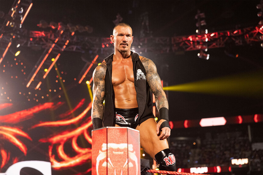 Randy Orton stands on the top rope of the ring