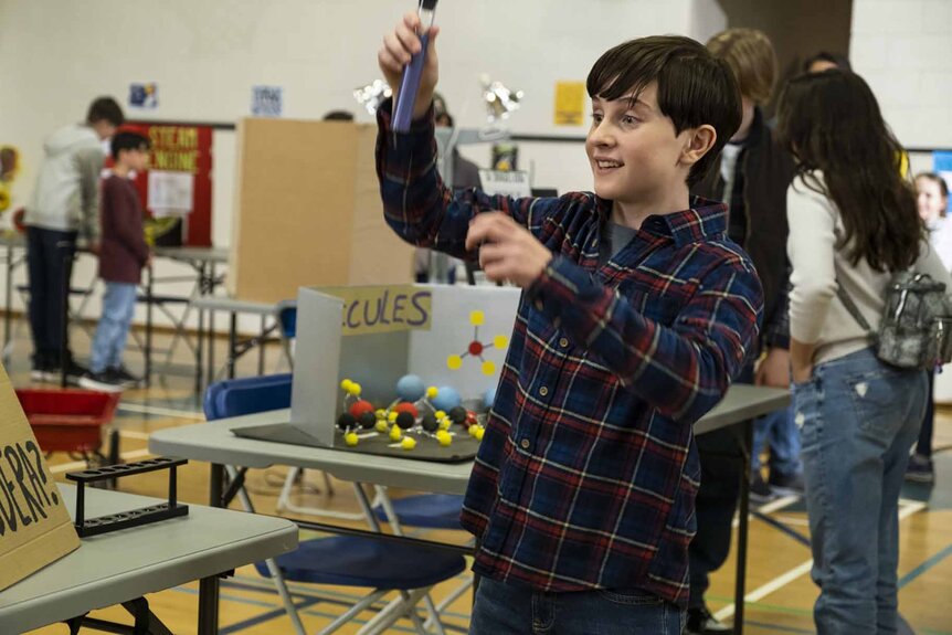 Max Hawthorne holds up a test tube in Resident Alien Episode 305.
