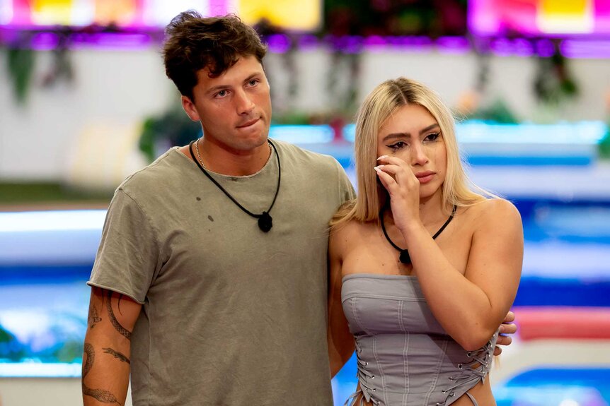 Robert Rausch with his arm around a crying Andrea Carmona in Love Island USA