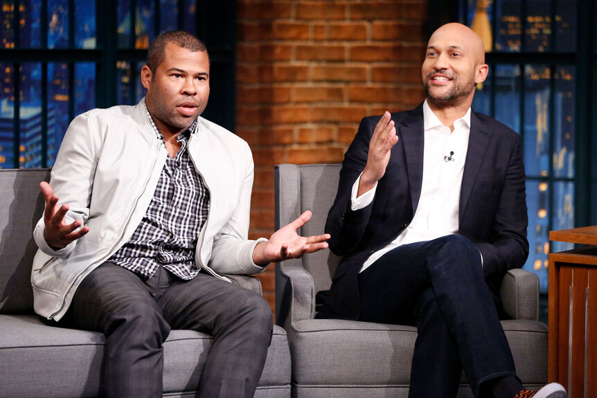 Jordan Peele and Keegan-Michael Key gesture during an interview on Late Night with Seth Meyers