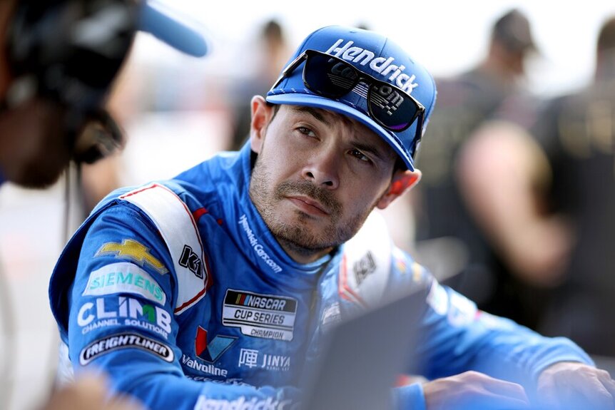 Kyle Larson speaking to a crew member during the Nascar Cup Series