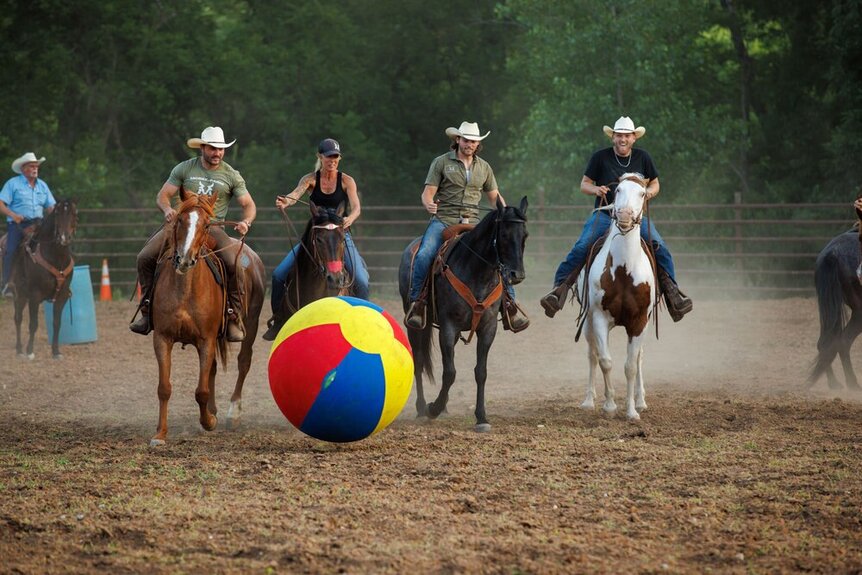 Cole McBee Jesse McBee Steven McBee Jr Brayden McBee playing with a beach ball on horses