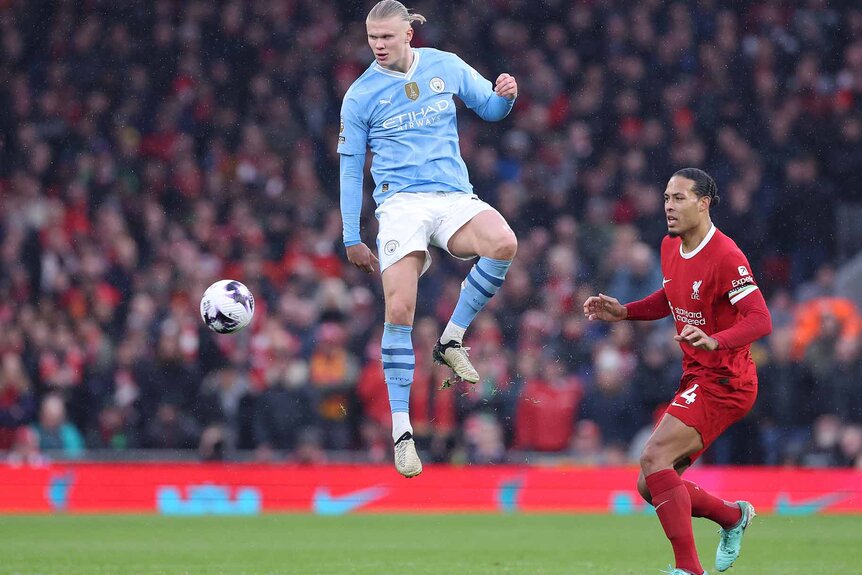 Erling Haalnd of Manchester City jumps in the air during a football match.