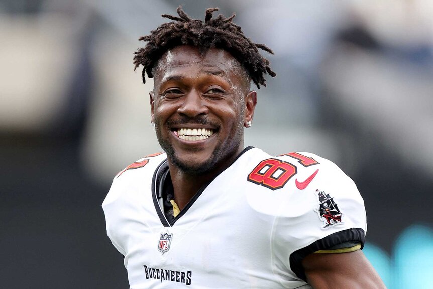 Antonio Brown smiling on the field before a game against the New York Jets.