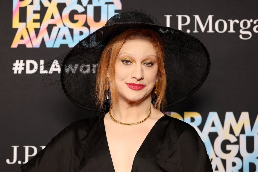 Jinkx Monsoon smiles in an all black outfit.