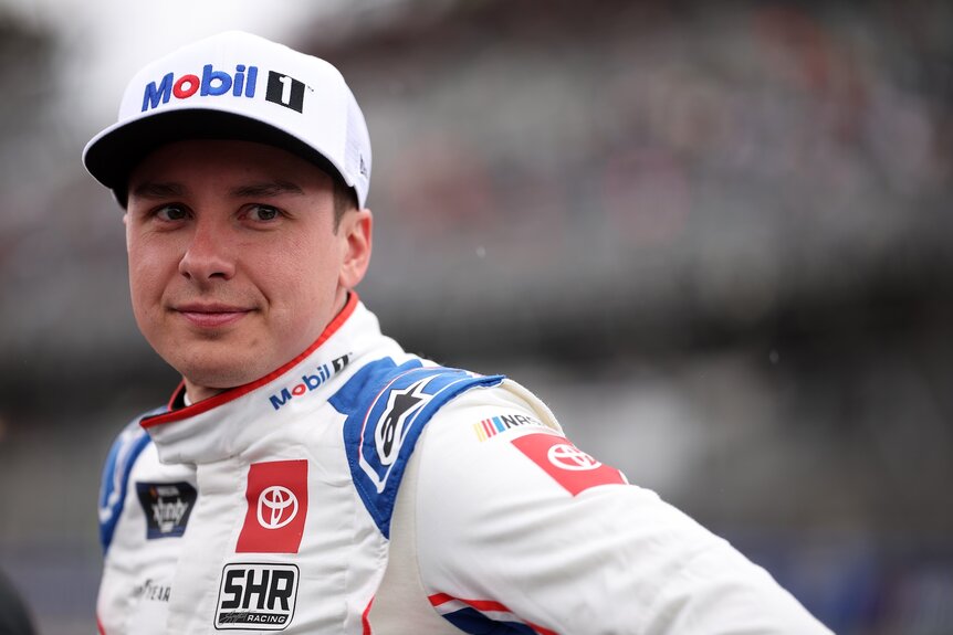 Christopher Bell smiles in his NASCAR suit.