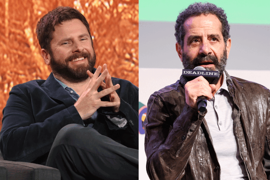 James Rodriguez sitting with his hands folded next to Tony Shalhoub speaking into a microphone.
