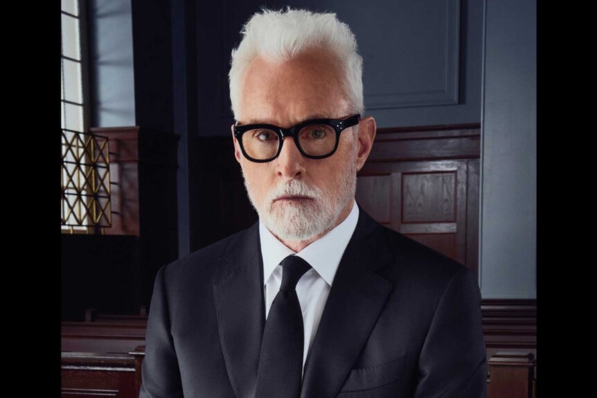 The Rainmaker star John Slattery posing as Leo Drummond in a courtroom